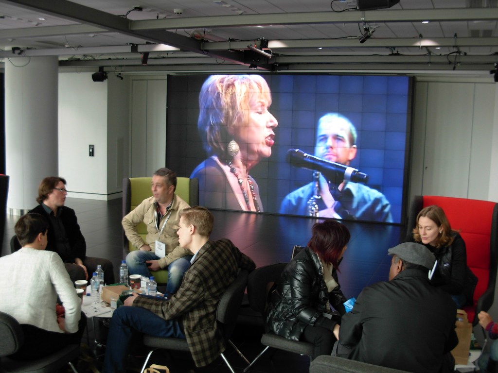 Conference attendees relaxing in the lobby area.